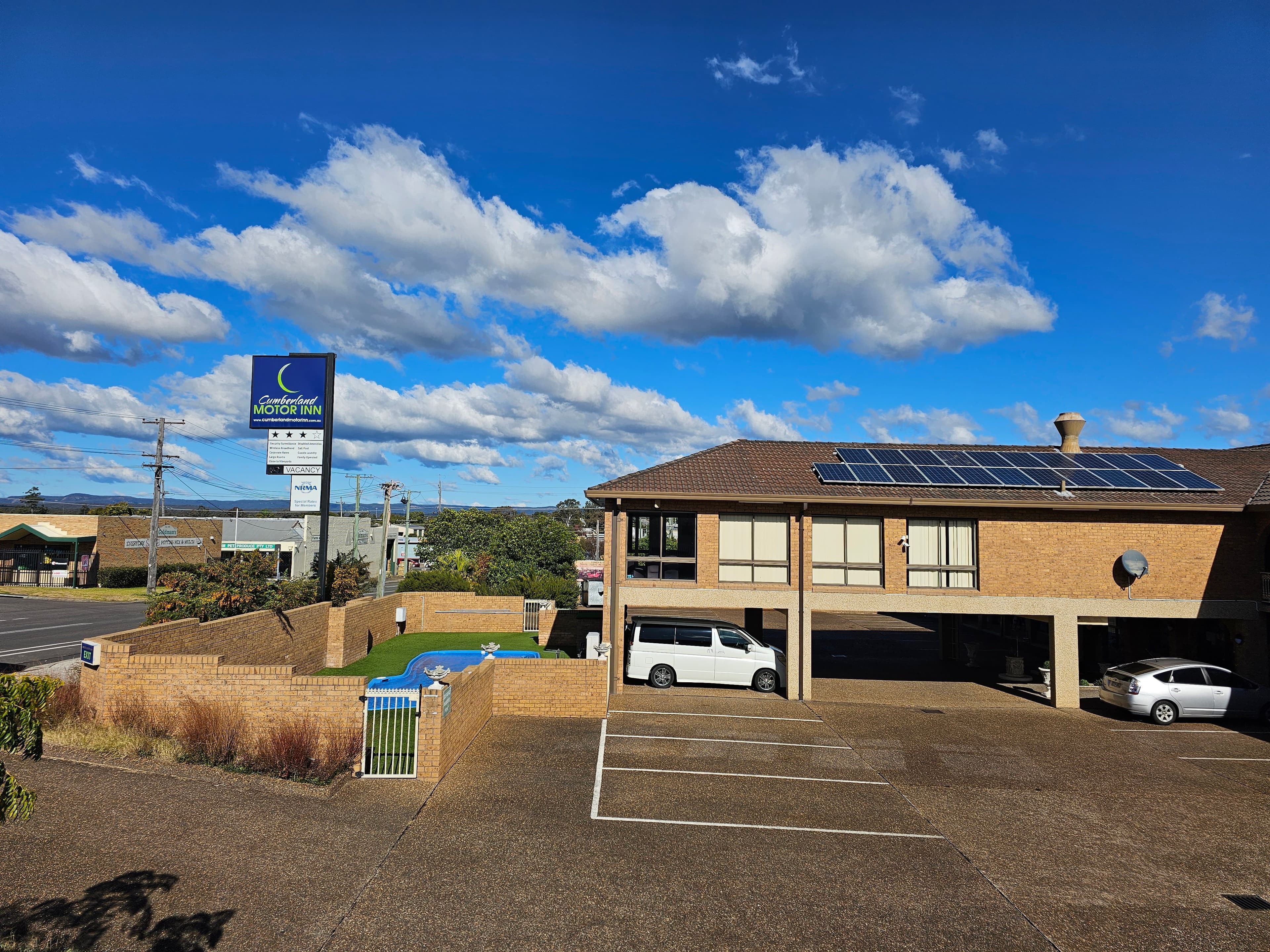 Outdoor salt-water pool and reception grounds at Cumberland Motor Inn